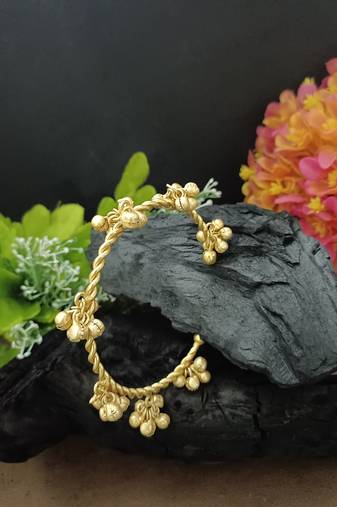 Gold-plated twisted kada bracelet with clustered ghungroo charms