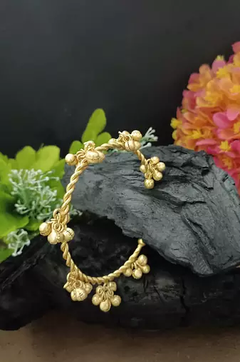 Gold-plated twisted kada bracelet with clustered ghungroo charms
