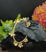 Gold-plated twisted kada bracelet with clustered ghungroo charms
