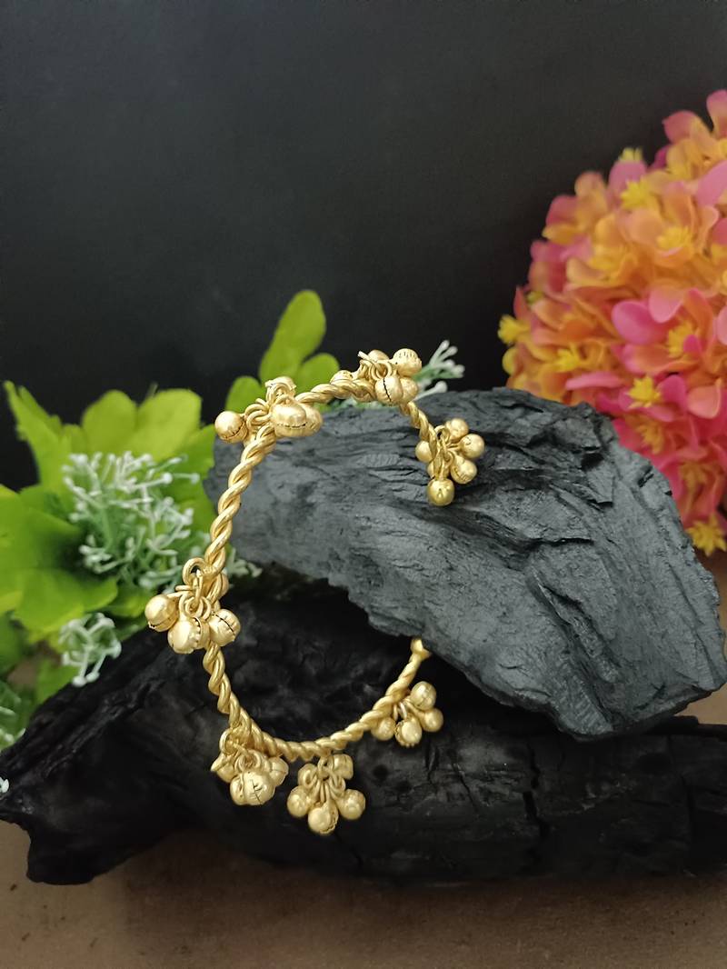 Gold-plated twisted kada bracelet with clustered ghungroo charms