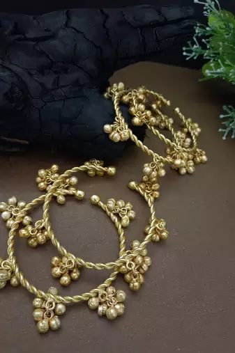 Set of 4 gold-plated twisted kada bracelet with clustered ghungroo charms