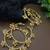 Set of 4 gold-plated twisted kada bracelet with clustered ghungroo charms