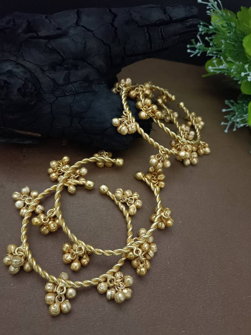 Set of 4 gold-plated twisted kada bracelet with clustered ghungroo charms