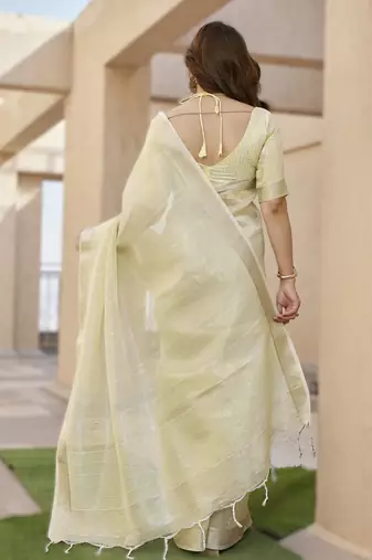 Light yellow soft tissue linen silk blend saree with all-over zari linings & rich zari pallu