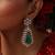 Gold plated kundan green stones dangler earrings