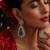Gold plated kundan green stones dangler earrings