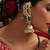 Gold plated kundan green stones jhumkas with ear chain