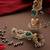 Gold plated kundan green stones jhumkas with ear chain