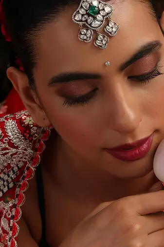 Gold plated kundan green stone mang tikka