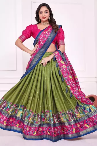 green patola print dola silk lehenga set with choli and dupatta with tassels