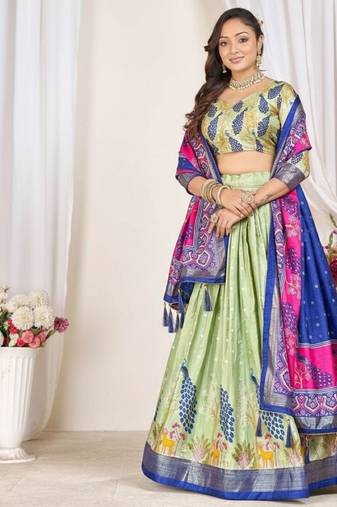 green patola print dola silk lehenga set with choli and dupatta with tassels