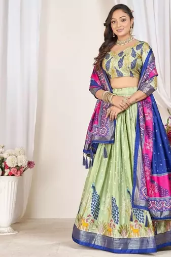 green patola print dola silk lehenga set with choli and dupatta with tassels
