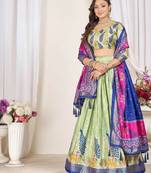 green patola print dola silk lehenga set with choli and dupatta with tassels