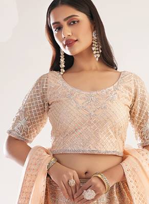 light peach net embroidered wedding wear lehenga with choli and dupatta 1