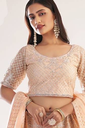 light peach net embroidered wedding wear lehenga with choli and dupatta