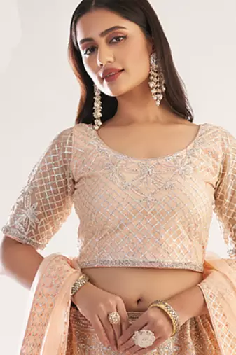 light peach net embroidered wedding wear lehenga with choli and dupatta