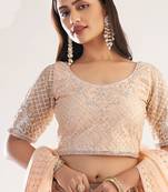 light peach net embroidered wedding wear lehenga with choli and dupatta