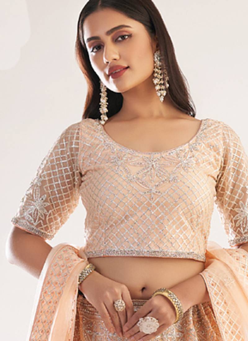 light peach net embroidered wedding wear lehenga with choli and dupatta