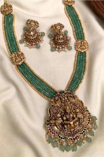 Antique gold-plated lakshmi long haram set with green beads & jhumkas – traditional temple jewelry