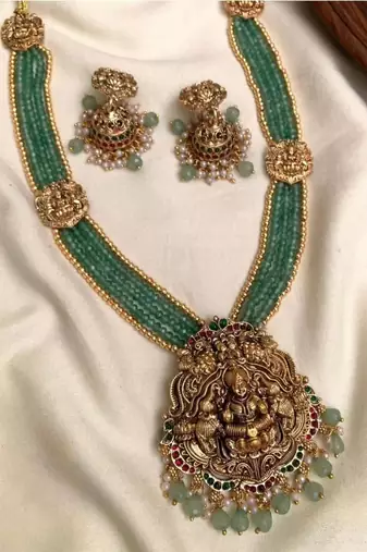 Antique gold-plated lakshmi long haram set with green beads & jhumkas – traditional temple jewelry