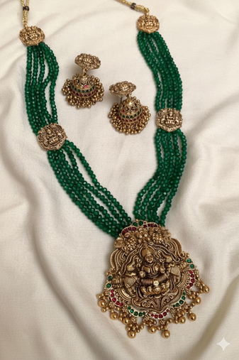 Antique gold-plated lakshmi long haram set with green beads & jhumkas – traditional temple jewelry