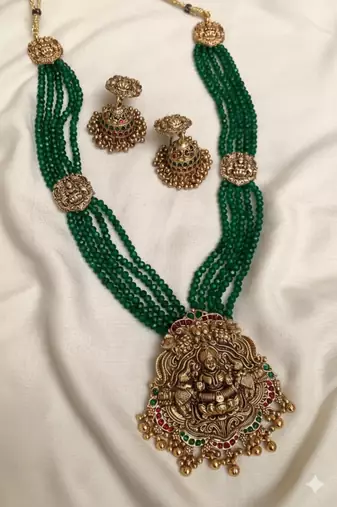 Antique gold-plated lakshmi long haram set with green beads & jhumkas – traditional temple jewelry