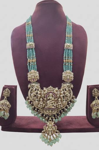 Antique gold-plated temple lakshmi haram necklace set with green beads & jhumka earrings