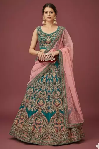 Alluring Teal Blue Thread Zari Dori And Sequins Embroidered Velvet Bridal Wear Lehenga Choli For Women
