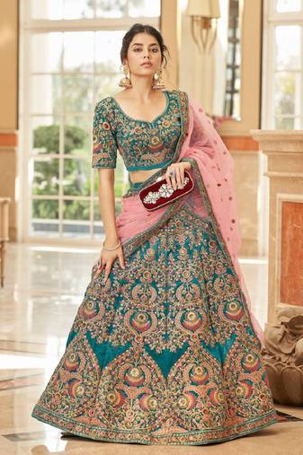 Alluring Teal Blue Thread Zari Dori And Sequins Embroidered Velvet Bridal Wear Lehenga Choli For Women