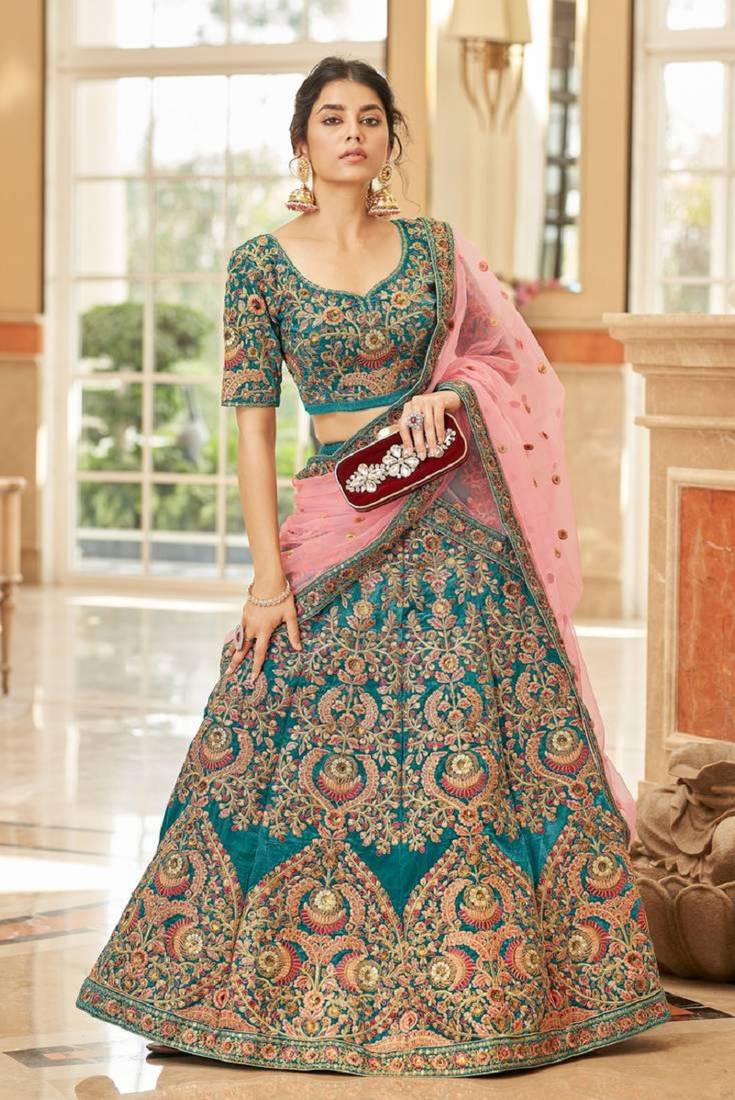 Alluring Teal Blue Thread Zari Dori And Sequins Embroidered Velvet Bridal Wear Lehenga Choli For Women