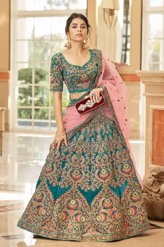 Alluring Teal Blue Thread Zari Dori And Sequins Embroidered Velvet Bridal Wear Lehenga Choli For Women