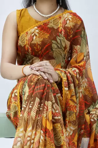 mustard floral printed georgette saree with lace border	