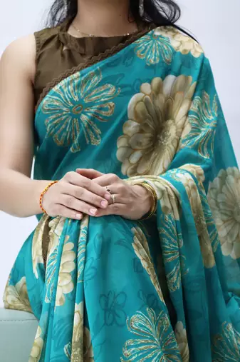turquoise floral printed georgette saree with lace border