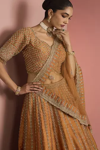 rust orange raw silk lehenga set with blouse and dupatta