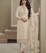 Cream silk embroidered salwar suit.