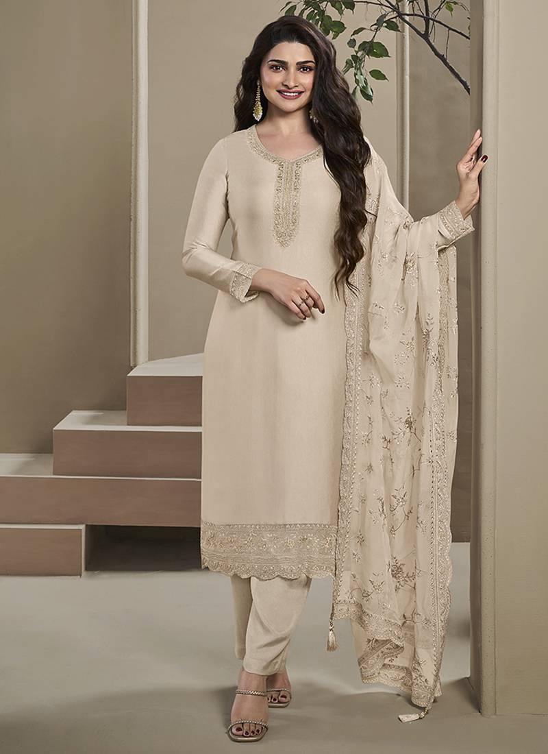 Cream silk embroidered salwar suit.