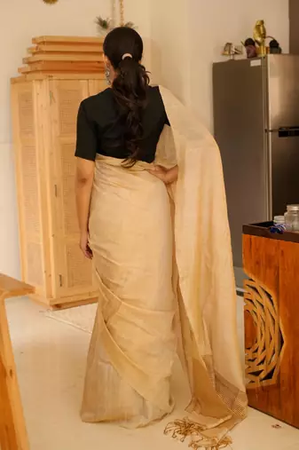 sunehri handwoven beige-gold tissue linen saree with subtle zari highlights