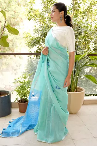 aqua blue linen saree with hand embroidered floral motifs