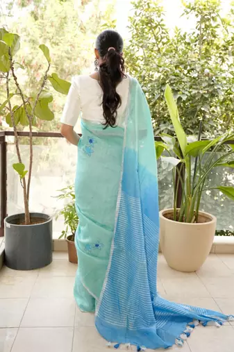 aqua blue linen saree with hand embroidered floral motifs