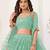 SEA GREEN NET SEQUIN EMBROIDERED LEHENGA SET WITH CHOLI AND DUPATTA