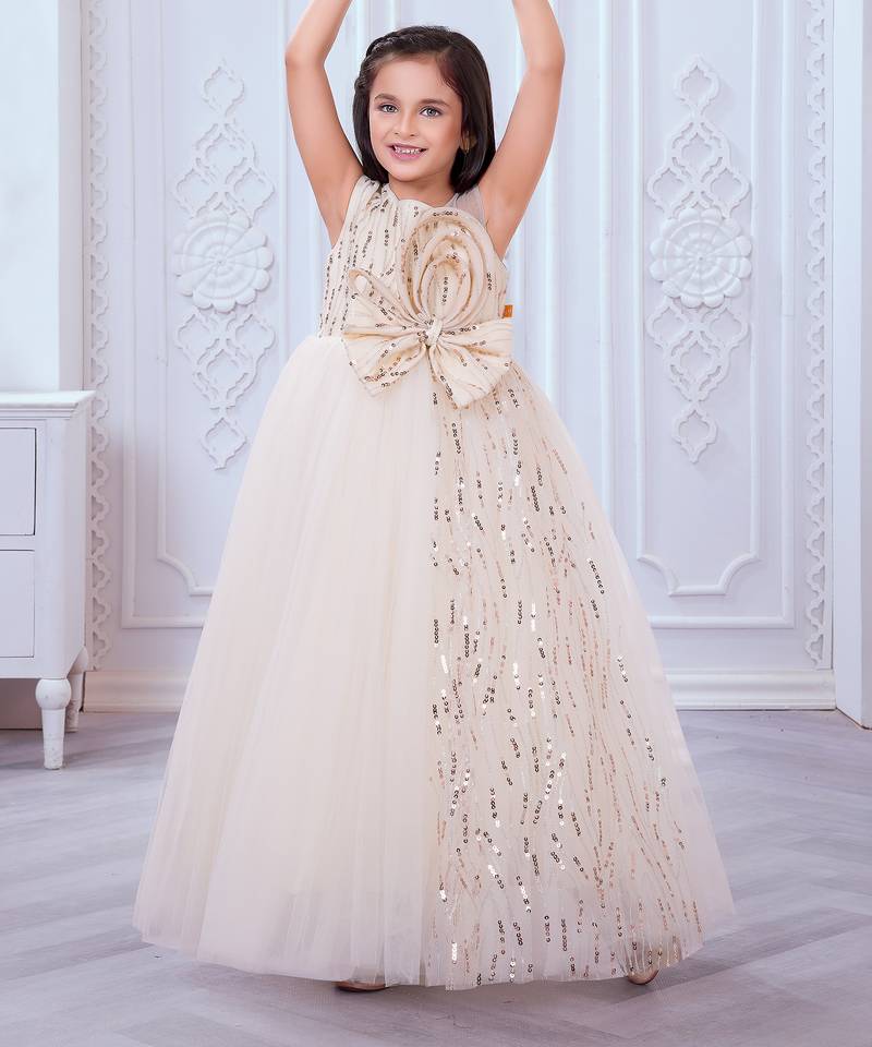 cream net gown with sequins and oversized bow