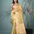 golden tissue saree with intricate embroidery and scalloped border