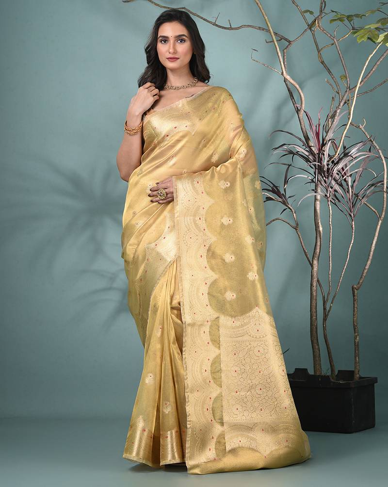 golden tissue saree with intricate embroidery and scalloped border