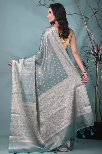 elegant teal tissue saree with intricate border