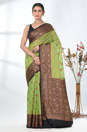 green georgette saree with red and gold border