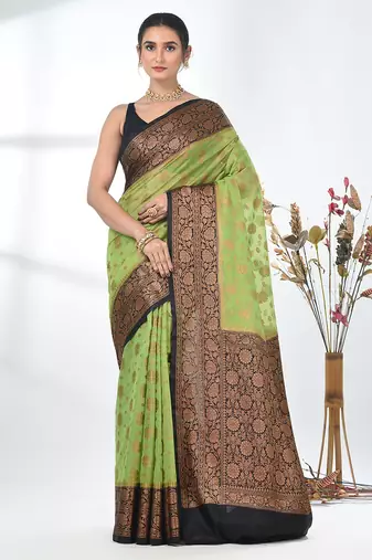 green georgette saree with red and gold border