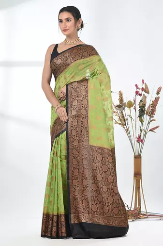 green georgette saree with red and gold border