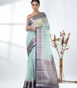 pastel blue organza saree with floral motifs and blue border
