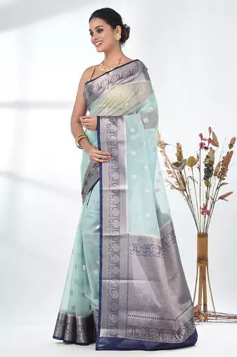 pastel blue organza saree with floral motifs and blue border