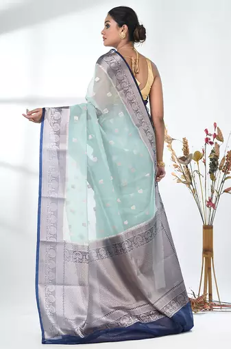 pastel blue organza saree with floral motifs and blue border